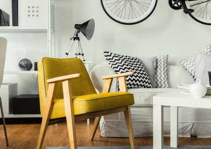 yellow chair in black and white apartment